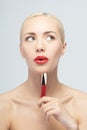 Beautiful woman applying lip gloss Royalty Free Stock Photo