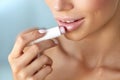 Beautiful Woman Applying Lip Protector On Lips Skin. Beauty Royalty Free Stock Photo