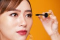 Beautiful woman applying mascara on her eyelashes Royalty Free Stock Photo