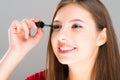 Beautiful woman applying mascara on her eyelashes Royalty Free Stock Photo