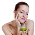 Beautiful woman applying moisturizer cream Royalty Free Stock Photo