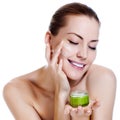 Beautiful woman applying moisturizer cream Royalty Free Stock Photo