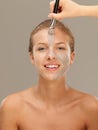 Beautiful woman applying mud mask with brush Royalty Free Stock Photo