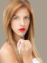 Beautiful woman applying red lipstick Royalty Free Stock Photo