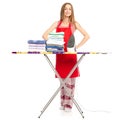 Beautiful woman in apron stack towels clean clothes ironing board iron Royalty Free Stock Photo