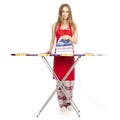 Beautiful woman in apron stack towels clean ironing board iron Royalty Free Stock Photo