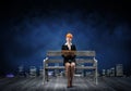 Beautiful woman architect sitting on wooden bench Royalty Free Stock Photo