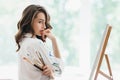 Beautiful woman artist with brushes posing in her studio Royalty Free Stock Photo