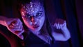 beautiful woman with artistic makeup is dancing hypnotically in darkness, closeup of face