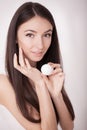 A beautiful woman asia using a skin care product, moisturizer or Royalty Free Stock Photo