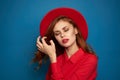 beautiful woman attractive look posing red hat blue background Royalty Free Stock Photo