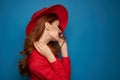 beautiful woman attractive look posing red hat blue background Royalty Free Stock Photo