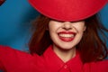 beautiful woman attractive look posing red hat blue background Royalty Free Stock Photo