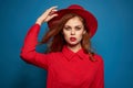 beautiful woman attractive look posing red hat blue background Royalty Free Stock Photo
