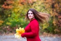 Beautiful woman in autumn, cute plus size model in red sweater outdoors