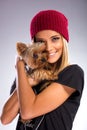 Beautiful woman with autumn fashion, holding yorkshire terrier dog