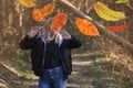 Beautiful woman in autumn landscape with trees in yellow orange red colors