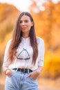 Fall concept - beautiful woman in autumn park under fall foliage Royalty Free Stock Photo