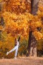 Fall concept - beautiful woman in autumn park under fall foliage Royalty Free Stock Photo