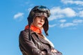 Beautiful woman in aviator helmet on the sky background