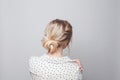 Beautiful woman back and head with blonde hairdo on white background Royalty Free Stock Photo