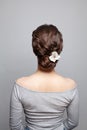 Beautiful woman back and head with perfect hairdo and white flowers on white background Royalty Free Stock Photo