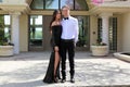 Beautiful woman in back prom dress and handsome guy in suit, teenager ready for a luxury night. Royalty Free Stock Photo