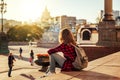 Beautiful woman in the background of a European city in the sun