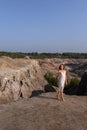 A beautiful woman on the background of landscape.Top view of the quarry