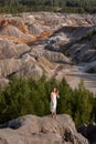 A beautiful woman on the background of landscape.Top view of the quarry