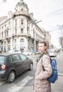 Beautiful woman with bagpack and sunglasses standing on the street in the Belgrade city, Serbia Royalty Free Stock Photo