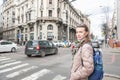 Beautiful woman with bagpack and sunglasses standing on the street in the Belgrade city, Serbia