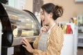 Beautiful woman bakery or coffee shop owner is smiling in her shop