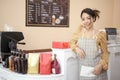 Beautiful woman bakery or coffee shop owner is smiling in her shop