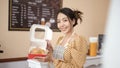 Beautiful woman bakery or coffee shop owner is smiling in her shop