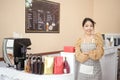 Beautiful woman bakery or coffee shop owner is smiling in her shop