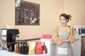 Beautiful woman bakery or coffee shop owner is smiling in her shop