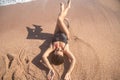 Beautiful woman in a bathing suit lying on the sand by the sea top view Royalty Free Stock Photo