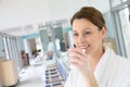 Beautiful woman in bathrobe drinking hot tea in spa center Royalty Free Stock Photo