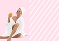 Beautiful woman in bathrobe on pastel pink background. Beauty and spa concept Royalty Free Stock Photo