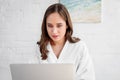 beautiful woman in bathrobe using laptop Royalty Free Stock Photo