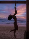 Beautiful woman on the beach and amazing colourful sunset Royalty Free Stock Photo