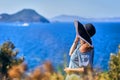 Beautiful woman in beach hat enjoying sea view with blue sky at sunny day in Bodrum, Turkey. Vacation Outdoors Seascape Summer Royalty Free Stock Photo