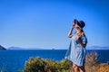 Beautiful woman in beach hat enjoying sea view with blue sky at sunny day in Bodrum, Turkey. Vacation Outdoors Seascape Summer Royalty Free Stock Photo