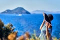 Beautiful woman in beach hat enjoying sea view with blue sky at sunny day in Bodrum, Turkey. Vacation Outdoors Seascape Summer Royalty Free Stock Photo