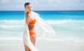 Beautiful woman on the beach in orange bikini Royalty Free Stock Photo