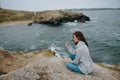 beautiful woman beach tourism cloudy weather stone coast Relaxation concept Royalty Free Stock Photo