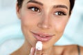 Beautiful Woman With Beauty Face Applies Balm On Lips. Skin Care Royalty Free Stock Photo