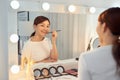 Beautiful Woman With Beauty Face Applying Lip Balm, Lipcare Stick On. Lips skincare cosmetics concept