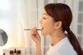 Beautiful Woman With Beauty Face Applying Lip Balm, Lipcare Stick On. Lips skincare cosmetics concept